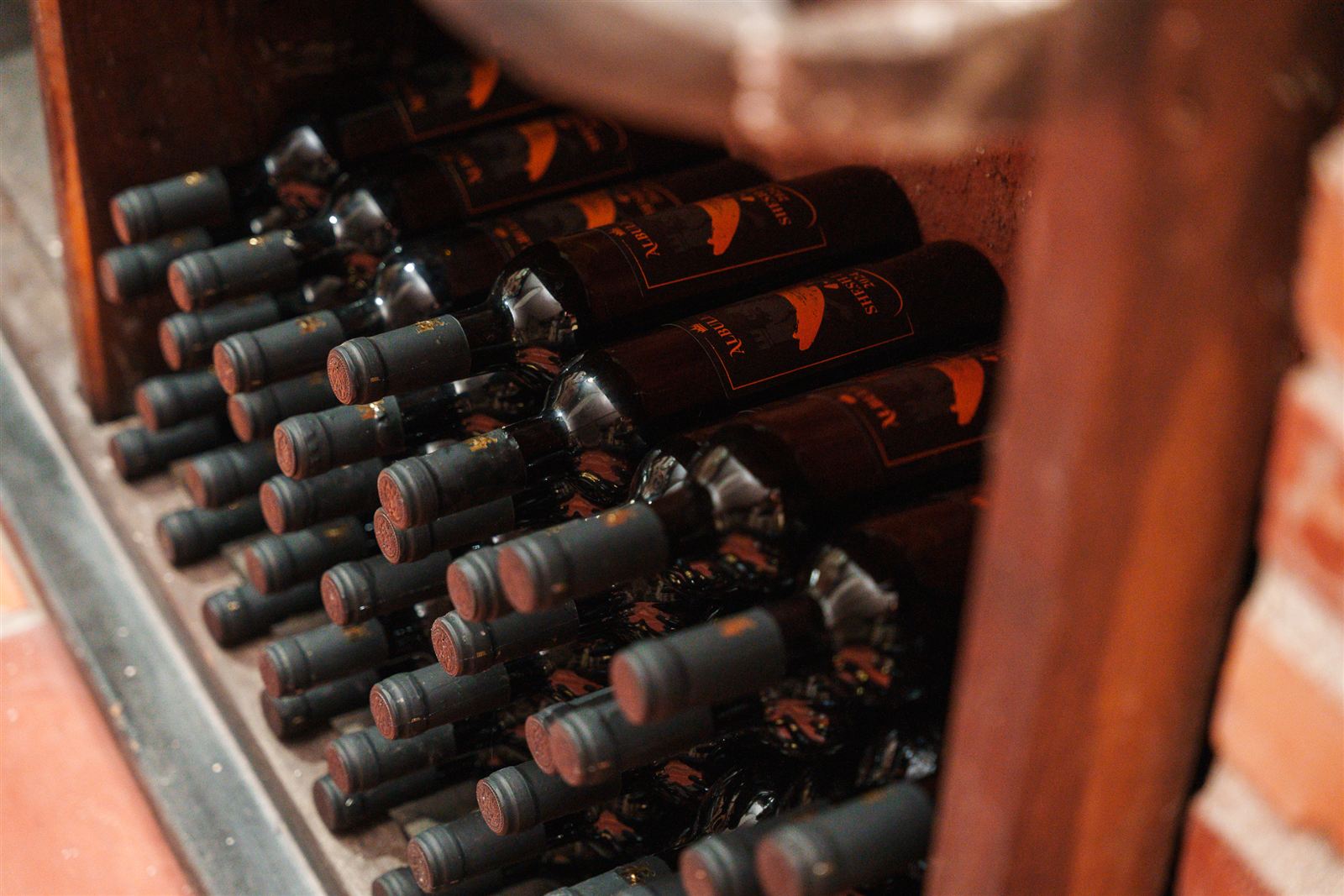 Estate wine cellar with bottles ageing in the cool stone room